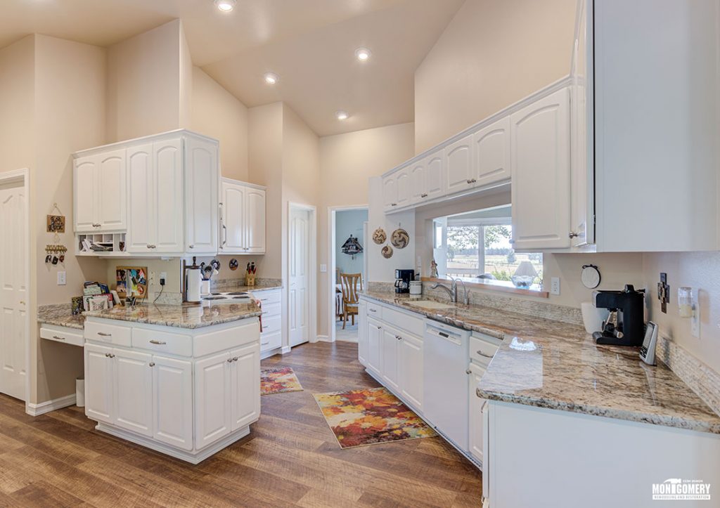 A narrow kitchen remodel but with enough cabinets and shelving to provide an open feeling while still hiding the clutter.